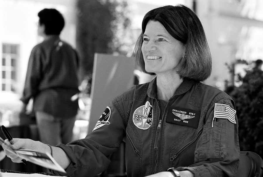 Sally Ride sitting in her uniform.
