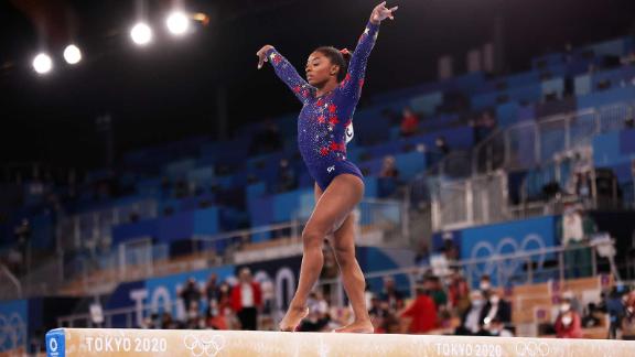 Simone Biles competing in the balance beam final at the 2020 Tokyo Olympics